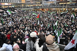 Syrier firar Assadregimens fall på Sergels torg i Stockholm på söndagen.