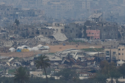 Palestinier promenerar genom ett förstört område i norra Gaza på söndagen, fotograferade från en plats i södra Israel.